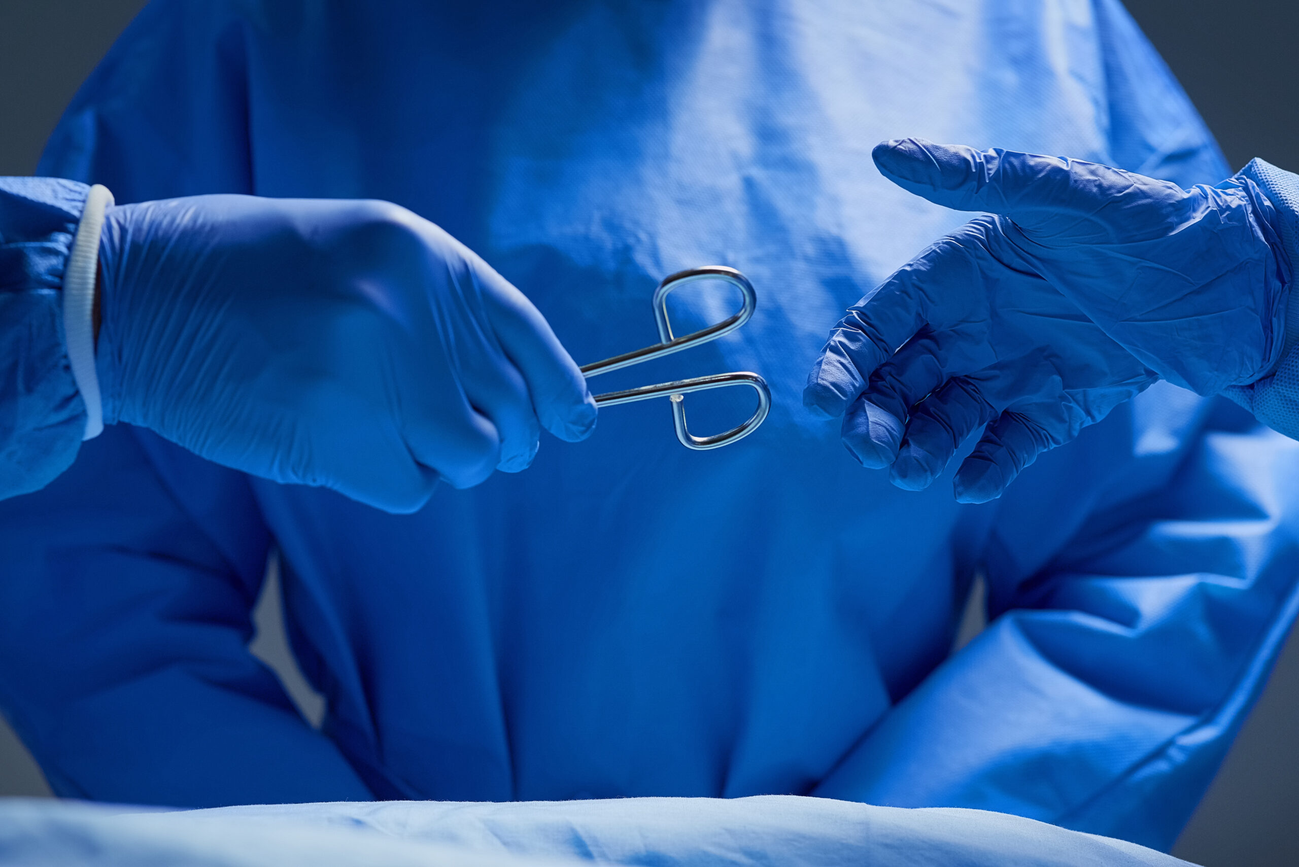 Forceps please. Closeup shot of group of surgeons working on a p
